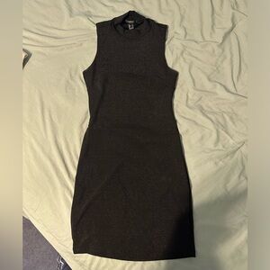 Shimmery mock turtle neck open back little black dress